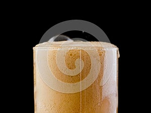 Ice cube in fizzy splashing water with soda