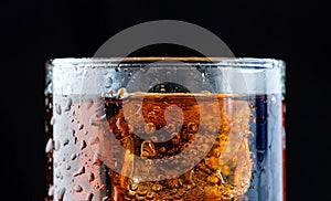 Ice cube in fizzy splashing water with soda