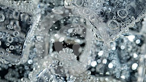 Ice cube in fizzy splashing water with soda photo