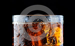 Ice cube in fizzy splashing water with soda