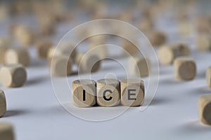 Ice - cube with letters, sign with wooden cubes