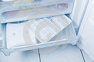 Ice cube maker in modern freezer