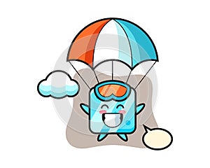 Ice cube mascot cartoon is skydiving with happy gesture