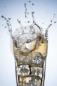Ice cube splashing on a glass