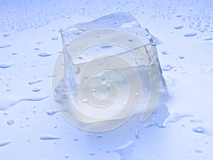 An ice cube with water droplets