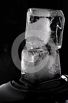 Ice cubes on black background. Low key photo