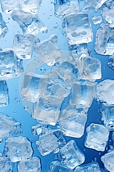 Ice cubes on blue glass background, pattern of crystal frozen icecubes