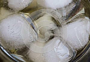 Ice cubes closeup in a soda or liquid