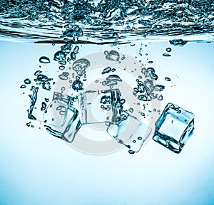 Ice cubes falling under water