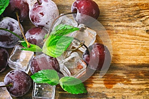 Ice cubes, frozen cherry, mint leaves macro