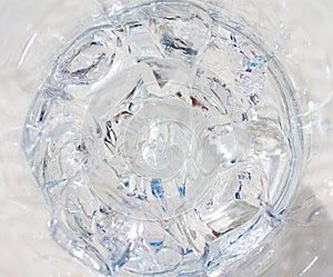 Ice cubes in a glass close up, top view.