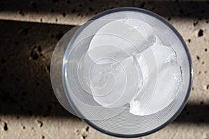 Ice cubes in a glass, top view with shadows