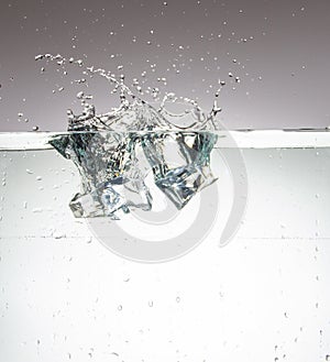 ice cubes that just fell into the water and leave a fountain