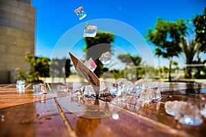 Ice Cubes and a Playing Card on a Wooden Table with Water Splashes