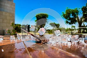 Ice Cubes and a Playing Card on a Wooden Table with Water Splashes