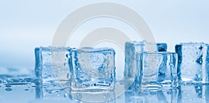 Ice cubes square with drops water clean on blue background