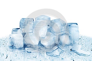 Ice cubes on white glass mirror background with reflection isolated close up, transparent frozen crushed blue ice cubes