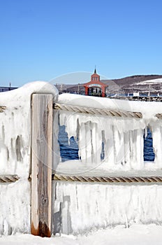 Ice curtain hangs off rope pier railing on Seneca Lake