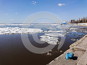 Ice drift on the river in spring. Embankment in the city of Saratov. Sunny day in April