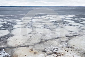 Ice drift in spring on Lake Onega, Karelia. Dangerous thin spring ice in April. Aggregate accumulations of fine