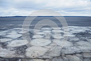 Ice drift in spring on Lake Onega, Karelia. Dangerous thin spring ice in April. Aggregate accumulations of fine