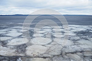 Ice drift in spring on Lake Onega, Karelia. Dangerous thin spring ice in April. Aggregate accumulations of fine