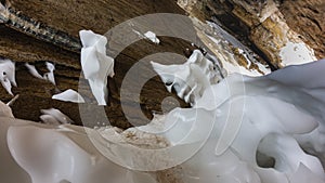 Ice drifts froze in bizarre shapes at the base of the granite rock