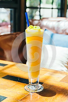 Ice drinking mango smoothie glass