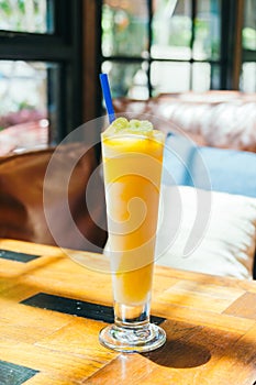 Ice drinking mango smoothie glass