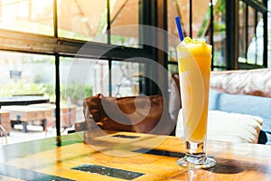 Ice drinking mango smoothie glass