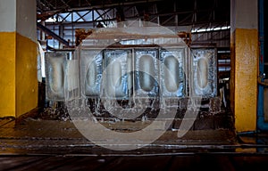 The Ice factory under working with industry machine which produce ices with ice factory background and sunlight rays background.