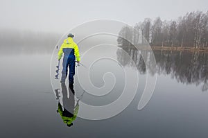 Ice fishing angler with reflection