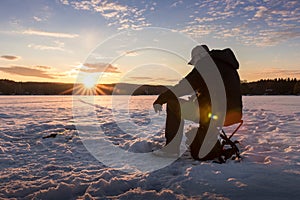 Ice fishing on a lake in Norway photo