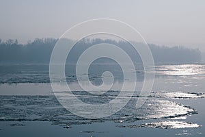 Ice floating in the river. Ice Break up. Sun reflection