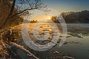 Ice floating in the river at orange sunrise