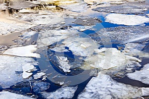 Ice floating on river in spring time. Melting of ice floe close-yp. photo