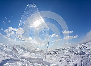 Ice floe and sun on winter Baikal lake