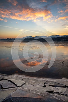 Ice floes on the lake shore. Colorful sky during sunrise on cold winter morning.Dam Liptovska Mara, Slovakia