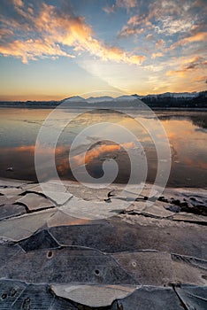 Ice floes on the lake shore. Colorful sky during sunrise on cold winter morning.Dam Liptovska Mara, Slovakia