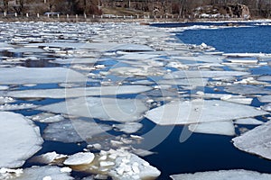 Ice floes on the surface of the river in early spring, ice drift, melting snow