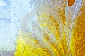 Ice flowers and frost pattern on frosty window glass