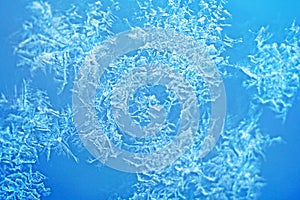 Ice flowers frozen blue window textured background