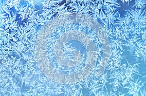 Ice flowers frozen texture on window background