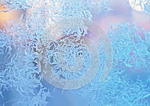 Ice flowers frozen texture on window background