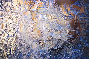 Ice flowers frozen on window. Winter cold textured pattern. Macro view. Frost crystal.