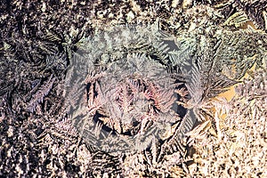 Ice flowers frozen on window. Winter cold textured pattern. Macro view. Frost crystal.