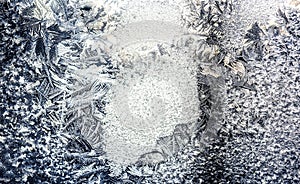 Ice flowers frozen on window. Winter cold textured pattern. Macro view. Frost crystal.