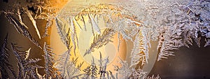 Ice flowers frozen on window. Winter cold textured pattern. Macro view. Frost crystal.