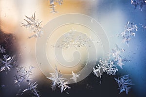 Ice flowers frozen on window. Winter cold textured pattern. Macro view. Frost crystal.