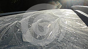 Ice flowers on the icy car roof